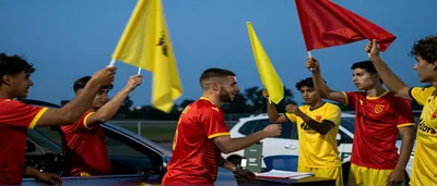 Louis Mafouta, mid-30s, muscular forward, wearing a plain yellow jersey with black sleeves and matching shorts, no logos...