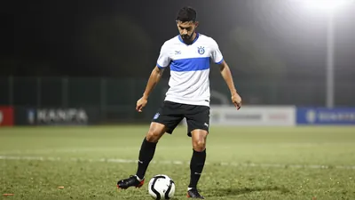 A photorealistic image of an anonymous Le Mans FC player in a white jersey with a blue stripe, a black pair of shorts...
