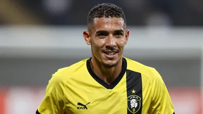A photorealistic image of an anonymous young Brazilian striker with a strong build, aged 20, wearing a yellow and black...